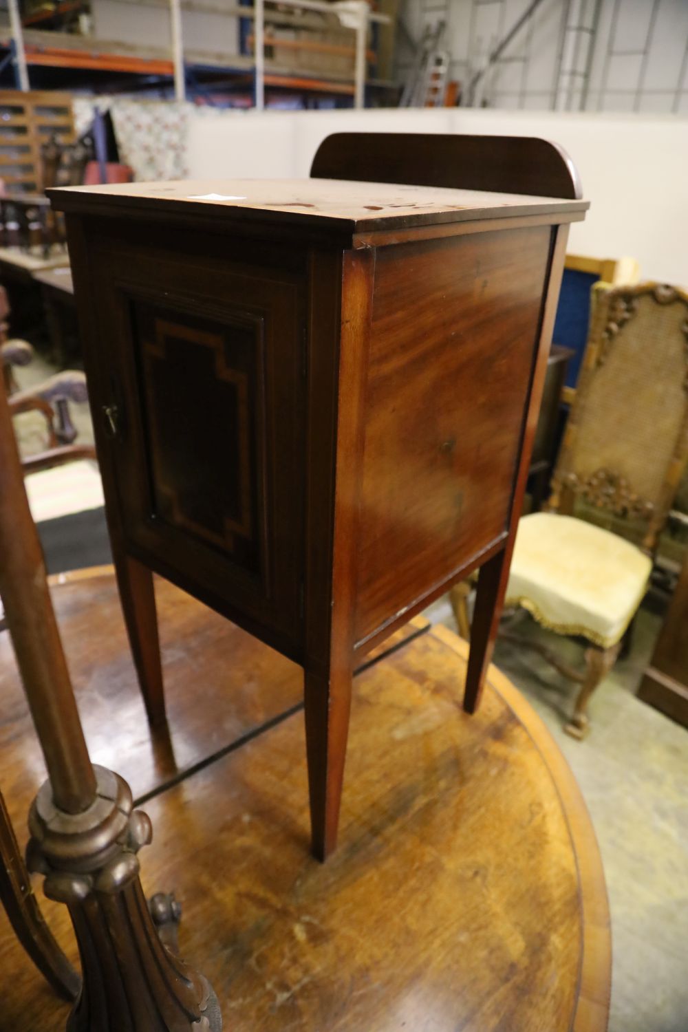 An Edwardian mahogany pot cupboard, an oval occasional table and a Victorian pole screen